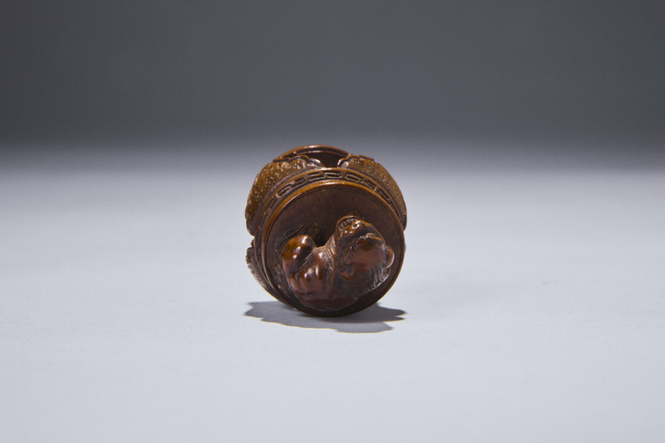 Boxwood Netsuke of a Shishi on a Table