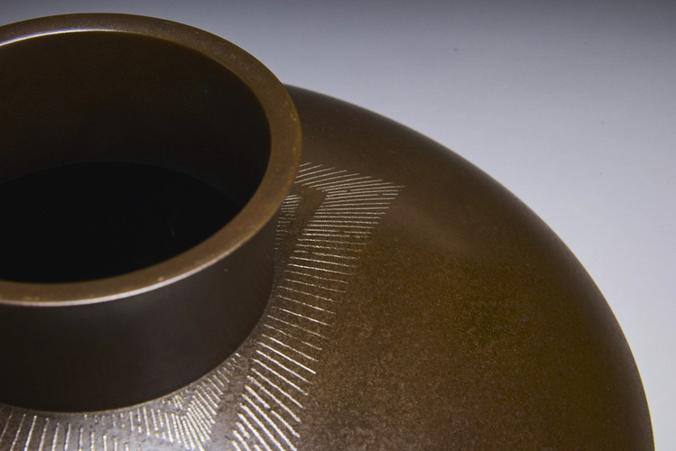 Flatted round bronze vase with fine silver inlay 