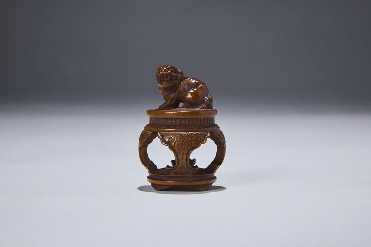 Boxwood Netsuke of a Shishi on a Table